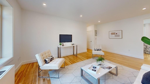 living area featuring recessed lighting, light wood-style floors, and baseboards