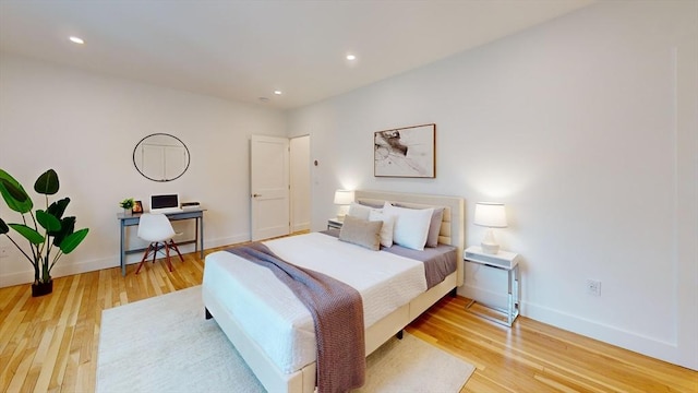 bedroom featuring recessed lighting, light wood-type flooring, and baseboards