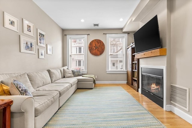 161 I St Unit 1, Boston, MA 02127 - living room with light wood-style floors, a glass covered fireplace, and recessed lighting