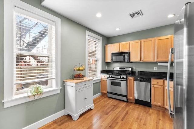 161 I St Unit 1, Boston, MA 02127 - kitchen featuring appliances with stainless steel finishes, plenty of natural light, light wood-style flooring, recessed lighting, and dark countertops