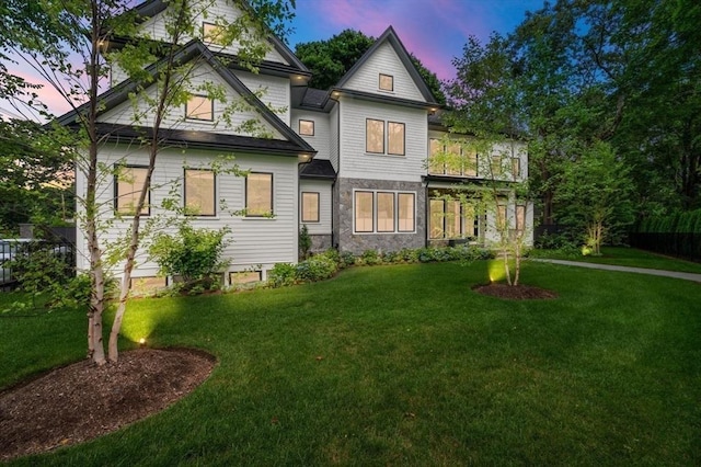 back house at dusk with a yard