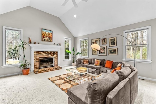 living area featuring a fireplace, carpet, and a healthy amount of sunlight