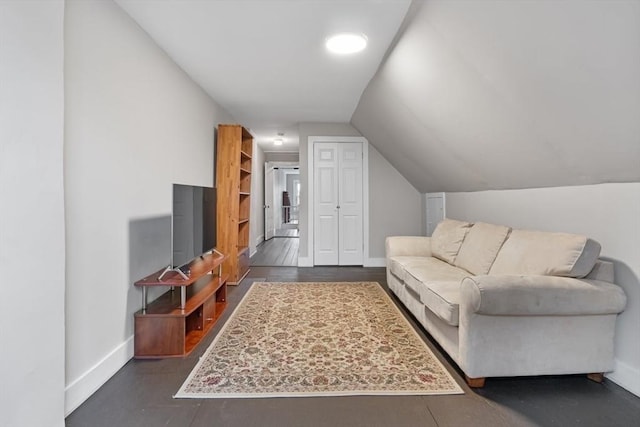 living room featuring baseboards and vaulted ceiling