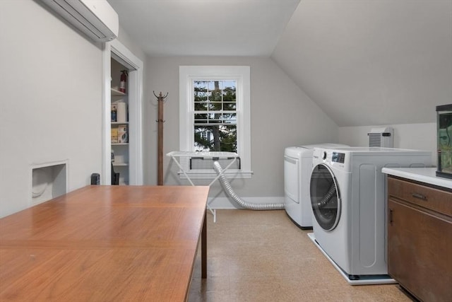 laundry room featuring laundry area, washer and dryer, and a wall unit AC