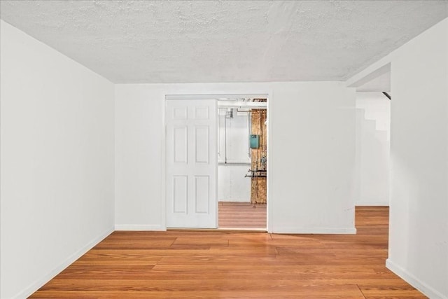 23 Vincent Cir, Worcester, MA 01604 - empty room with light wood-style flooring, a textured ceiling, and baseboards