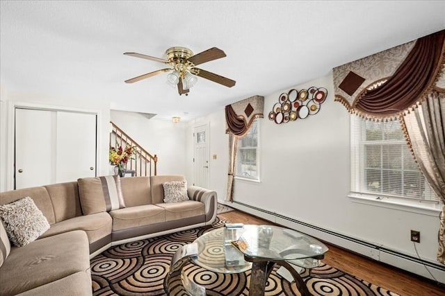 23 Vincent Cir, Worcester, MA 01604 - living room with a baseboard radiator, wood finished floors, ceiling fan, and stairs