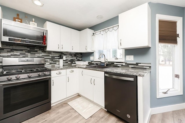 kitchen featuring white cabinetry, appliances with stainless steel finishes, and sink