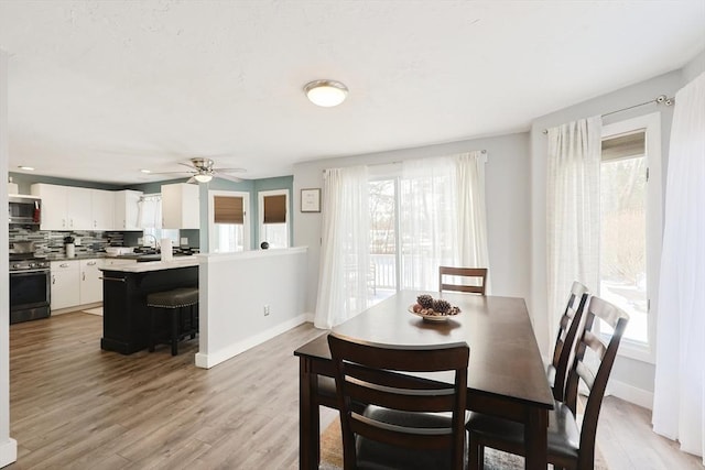 dining area featuring light hardwood / wood-style flooring, plenty of natural light, and ceiling fan