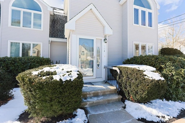 view of snow covered property entrance