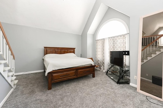 carpeted bedroom with lofted ceiling