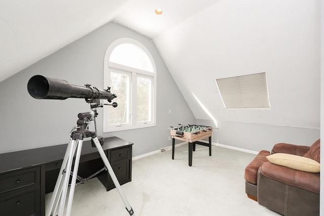 carpeted home office featuring vaulted ceiling