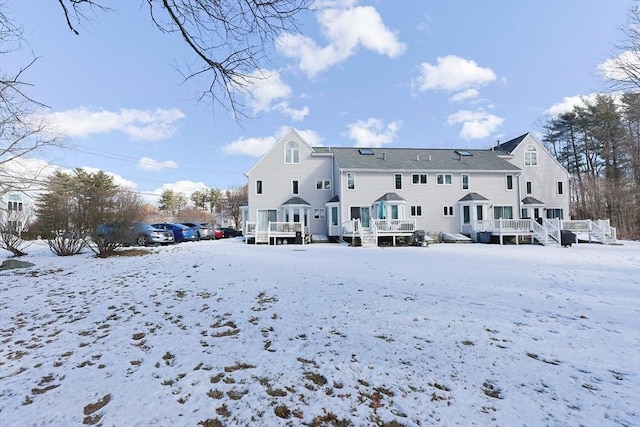 snow covered property featuring a deck