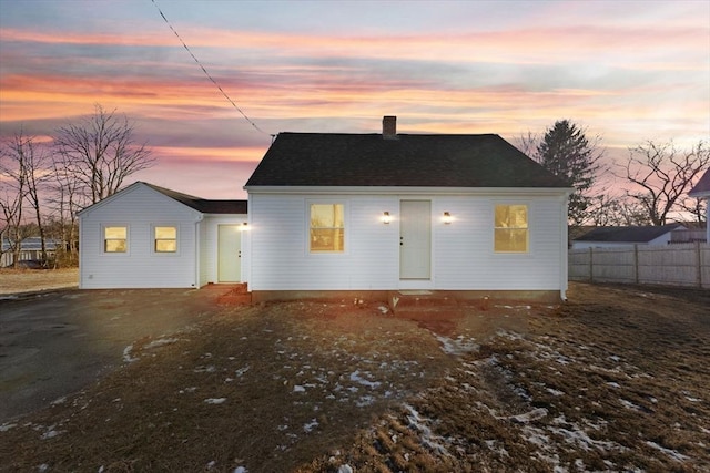 view of back house at dusk