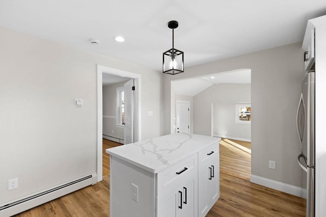 kitchen featuring a baseboard radiator, a kitchen island, and white cabinets