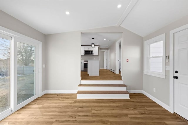 entryway with plenty of natural light, light wood-type flooring, and baseboard heating