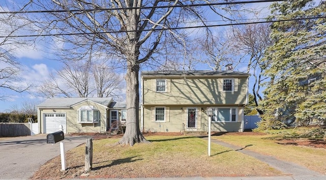 view of front of house featuring a front yard and a garage