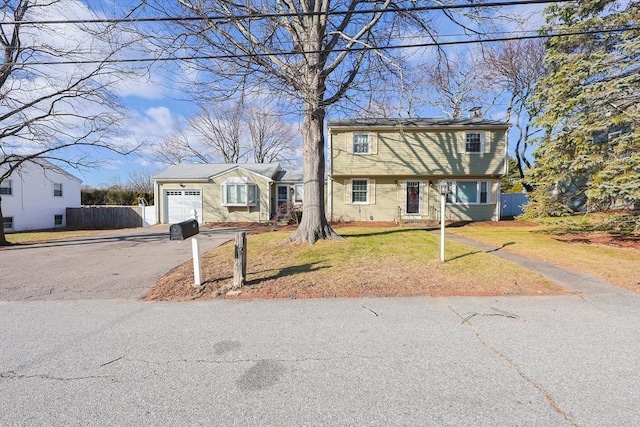 view of front of house with a front lawn and a garage