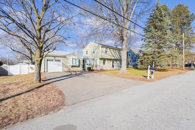 front facade featuring a front yard and a garage