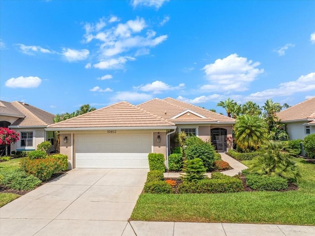 10852 Tiberio Dr, Fort Myers, FL 33913 - ranch-style home with a tile roof, driveway, a garage, and stucco siding