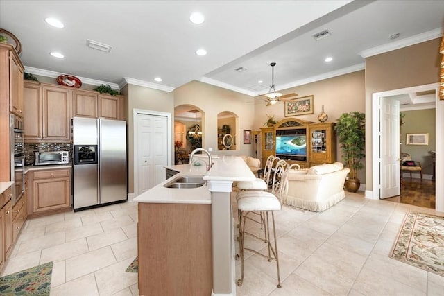 10852 Tiberio Dr, Fort Myers, FL 33913 - kitchen featuring stainless steel refrigerator with ice dispenser, visible vents, a sink, and crown molding