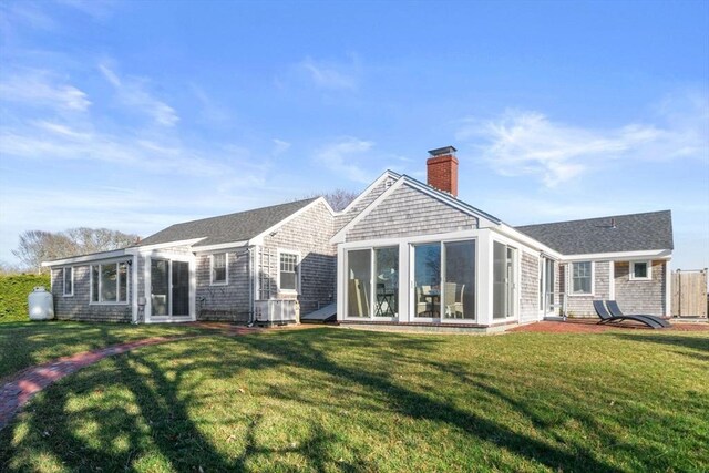 30 Captain Nickerson Ln, Dennis, MA 02660 - back of property with a lawn, a shingled roof, a chimney, and a sunroom