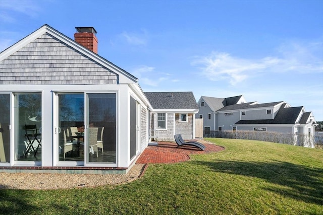 30 Captain Nickerson Ln, Dennis, MA 02660 - rear view of property with a lawn and a chimney