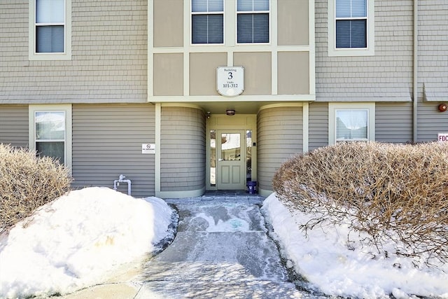 view of snow covered property entrance