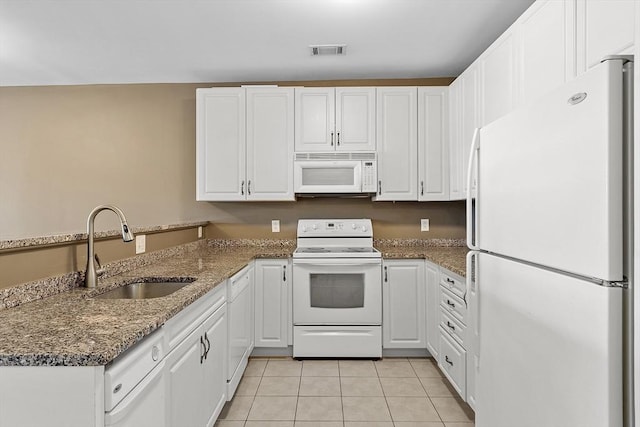 kitchen featuring a peninsula, white appliances, visible vents, and white cabinets