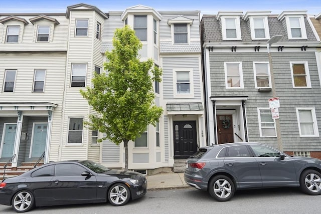 townhome / multi-family property with mansard roof