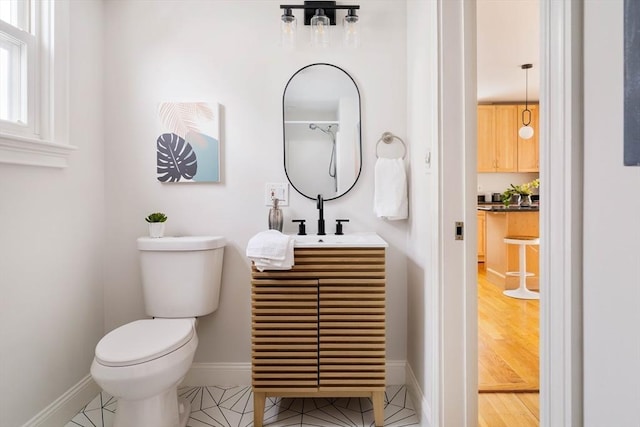 full bathroom with toilet, baseboards, and vanity