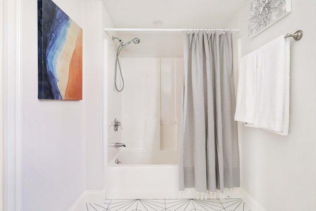 bathroom featuring shower / tub combo, tile patterned flooring, and baseboards