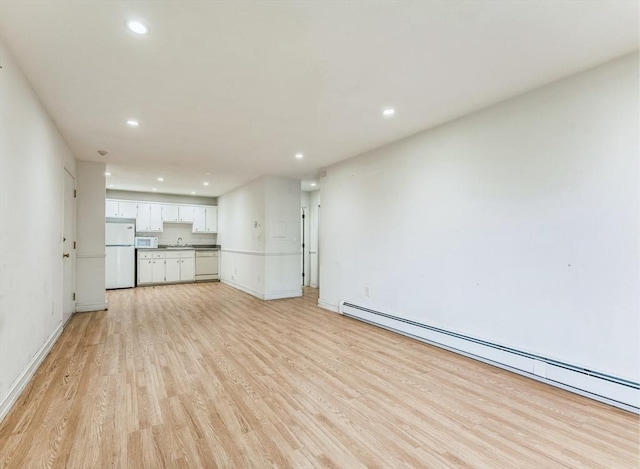 395 Merrimack St Unit 35, Methuen, MA 01844 - unfurnished living room with a baseboard radiator, light wood-style floors, and recessed lighting