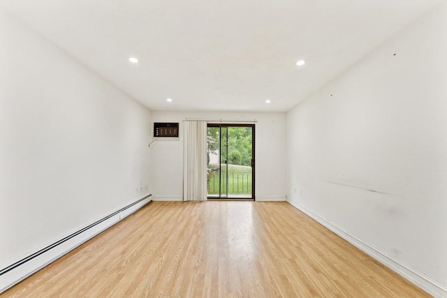 395 Merrimack St Unit 35, Methuen, MA 01844 - empty room featuring a baseboard radiator, wood finished floors, recessed lighting, and a wall unit AC