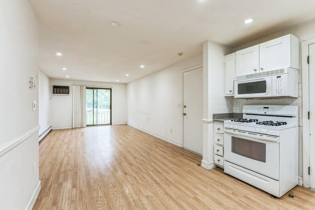 395 Merrimack St Unit 35, Methuen, MA 01844 - kitchen featuring white appliances, a wall unit AC, light wood-style floors, white cabinets, and a baseboard heating unit