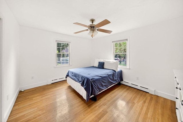 9 Arrowhead Ln, Dartmouth, MA 02748 - bedroom featuring a baseboard heating unit, light wood-type flooring, and a ceiling fan