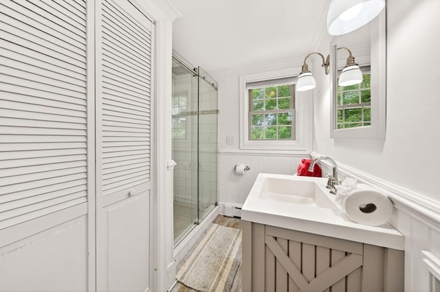 9 Arrowhead Ln, Dartmouth, MA 02748 - bathroom with a stall shower, vanity, wainscoting, a baseboard heating unit, and crown molding