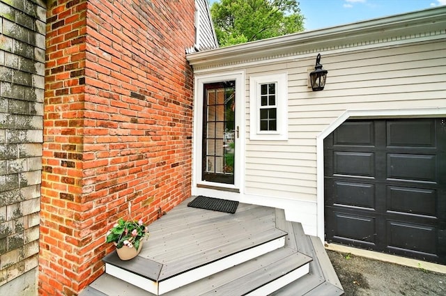 9 Arrowhead Ln, Dartmouth, MA 02748 - view of exterior entry featuring brick siding and a garage