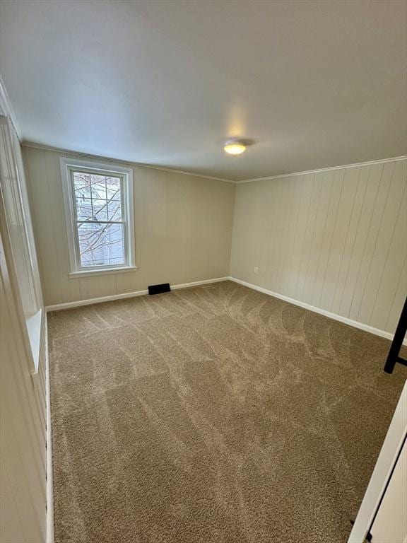 carpeted spare room with crown molding