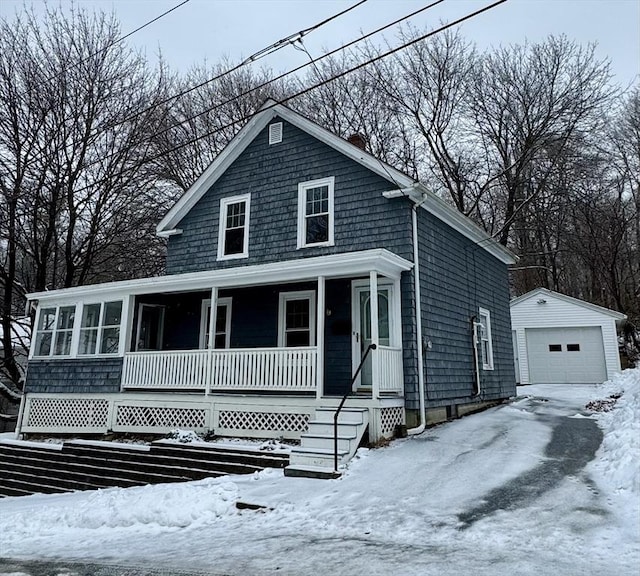 view of front of property with a porch, a garage, and an outdoor structure