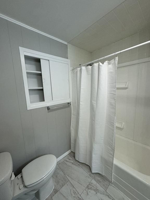 bathroom with shower / bath combination with curtain and toilet