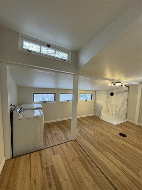 additional living space with separate washer and dryer and light hardwood / wood-style flooring