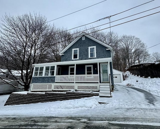 view of front of property with a garage and an outdoor structure