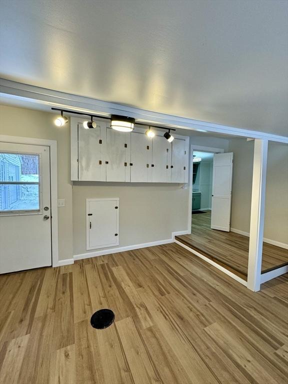 interior space featuring white cabinets and light wood-type flooring