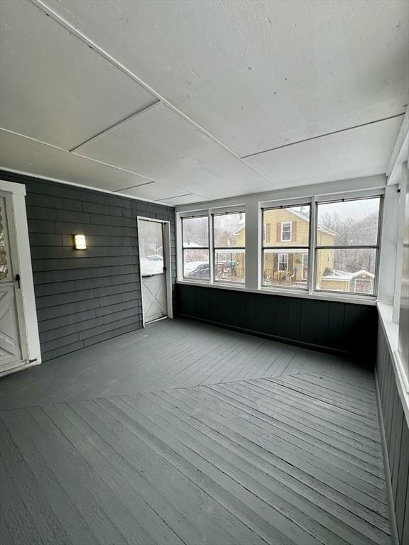 unfurnished sunroom featuring a wealth of natural light