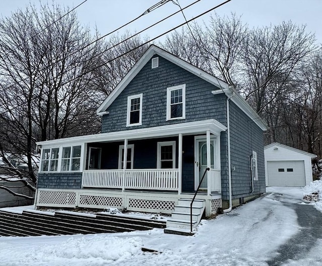 view of front facade featuring a garage and an outbuilding