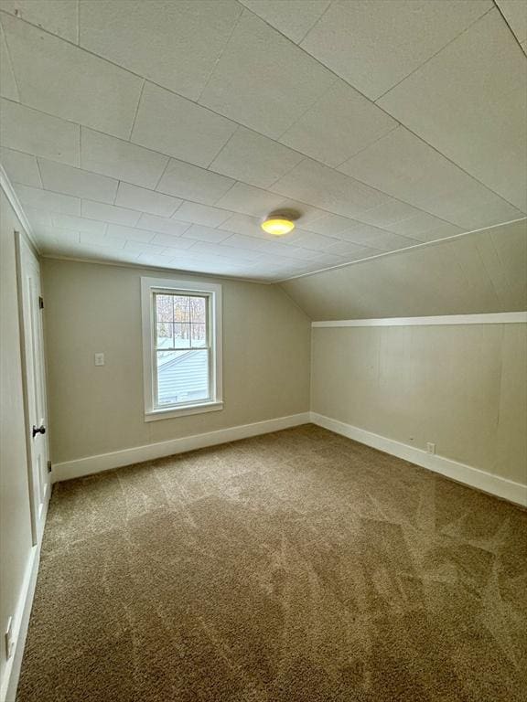 bonus room featuring lofted ceiling and carpet flooring