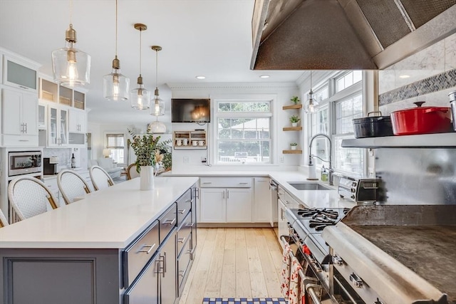 72 Oliver Snow Rd, Harwich, MA 02646 - kitchen featuring custom range hood, a sink, a center island, light wood-style floors, and hanging light fixtures