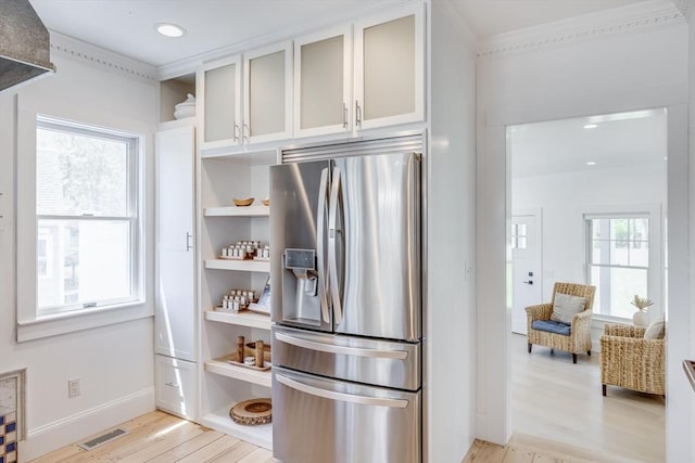 72 Oliver Snow Rd, Harwich, MA 02646 - kitchen featuring stainless steel refrigerator with ice dispenser, open shelves, light wood-style floors, ornamental molding, and white cabinetry