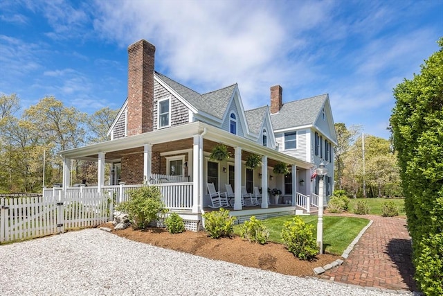 72 Oliver Snow Rd, Harwich, MA 02646 - back of house with covered porch, a chimney, and a shingled roof