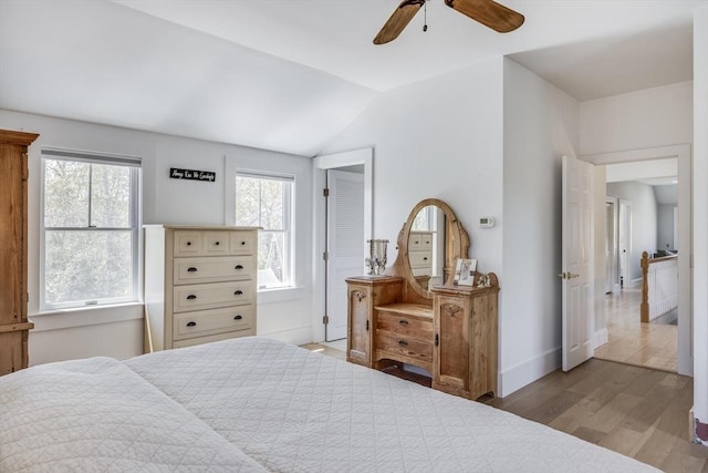 72 Oliver Snow Rd, Harwich, MA 02646 - bedroom featuring wood finished floors, vaulted ceiling, a ceiling fan, and baseboards